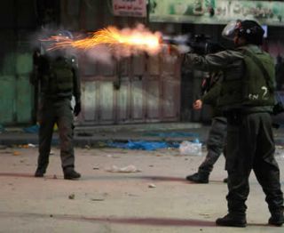 Tentara Israel sewenang-wenang menembakkan gas air mata saat bentrokan di Hebron, 6 Desember 2012. (Reuters / Stringer)