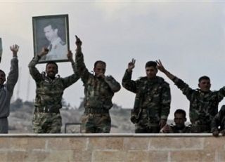 Pasukan Suriah membawa poster Presiden Suriah, Bashar Al-Assad (inet)