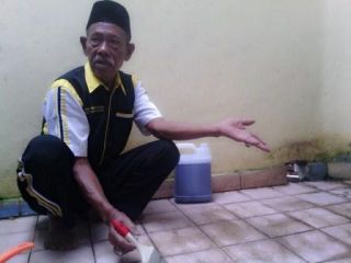 Pak Lili (75 tahun), Relawan 'Toilet Revolution' sedang membersihkan tempat wudhu (foto: humas)