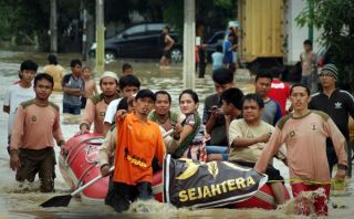 Relawan PKS mengevakuasi warga koraban banjir - Foto: tribunnews.com