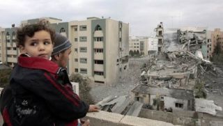 A Palestinian man looks at a destroyed building of the Islamic University following an Israeli air strike in Gaza December 29, 2008. Israeli warplanes pounded the Hamas-ruled Gaza Strip for a third consecutive day on Monday and the Jewish state prepared to launch a possible invasion after killing 307 Palestinians in the air raids. (REUTERS/Mohammed Salem)