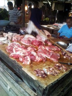 Penjual daging babi di pasar tradisional di Kupang. Di sini daging babi murah dan mudah didapat. (Darso Arief Bakuama)